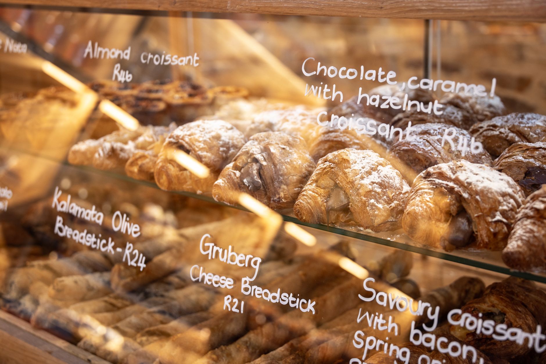 Croissants and pastries in a bakery display case