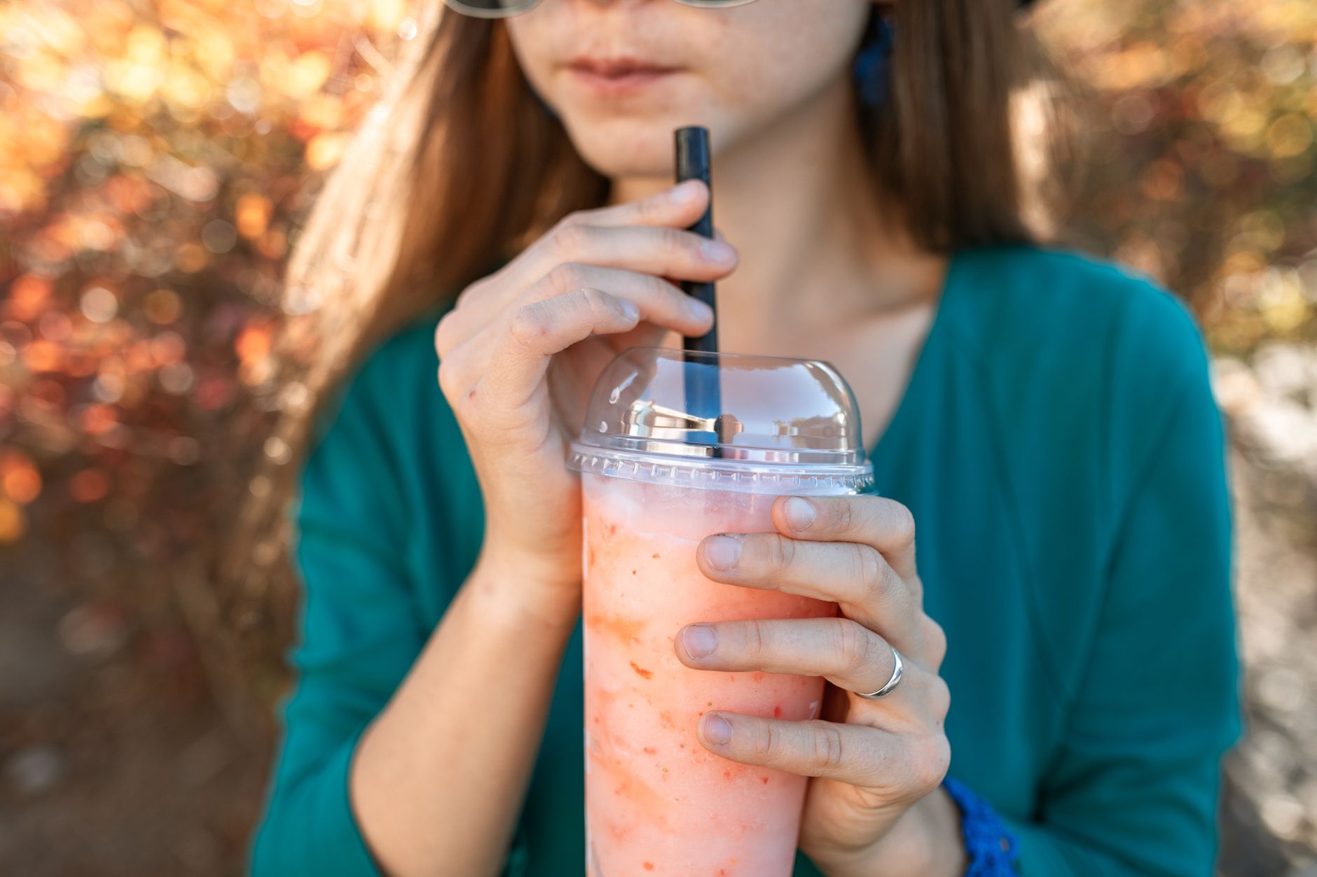 Person holding a cup of bubble tea outdoors