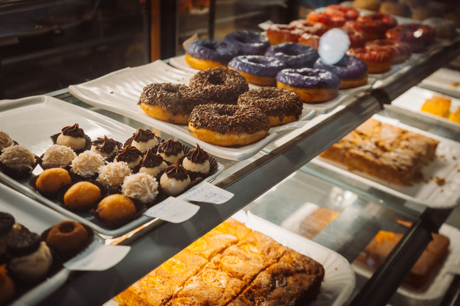 Assorted donuts and pastries in a bakery display case